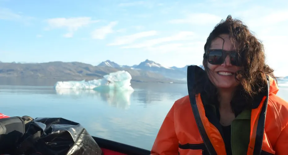 Researcher Angela Gallego Sala on a ship beside icebergs